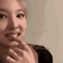 A Close Up Of A Woman Eating A Piece Of Food . GIF