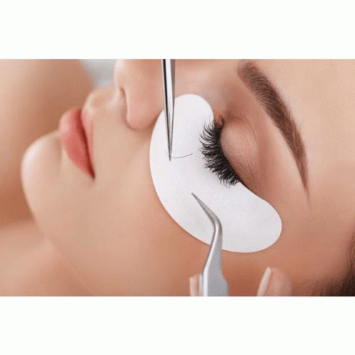 A Close Up Of A Woman Getting Her Eyelashes Extended GIF
