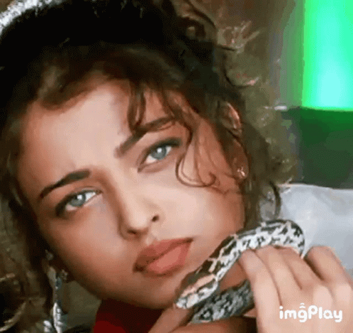 A Close Up Of A Woman Holding A Snake Around Her Neck GIF
