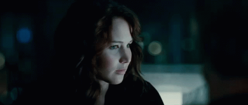 A Close Up Of A Woman In A Dark Room GIF