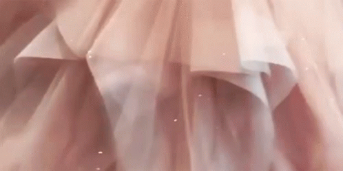 A Close Up Of A Woman In A Pink Dress GIF