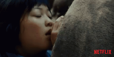 A Close Up Of A Woman Kissing A Rock With Netflix Written In Red On The Bottom GIF