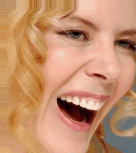 A Close Up Of A Woman Laughing With Her Mouth Open GIF
