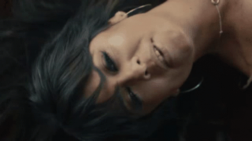 A Close Up Of A Woman Laying Face Down GIF