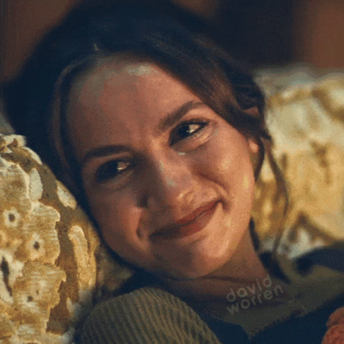 A Close Up Of A Woman Laying On A Couch With The Name David Worren Written On The Bottom GIF