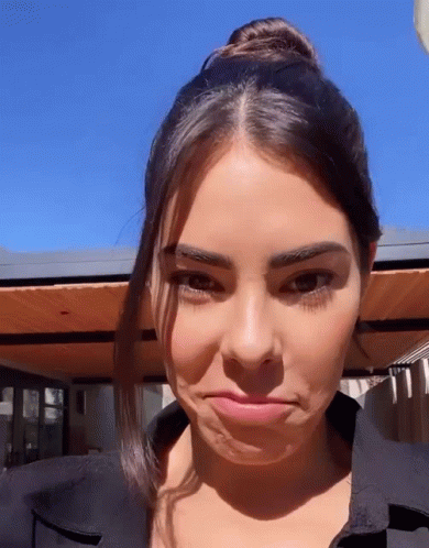 A Close Up Of A Woman Making A Face With Her Mouth Open GIF