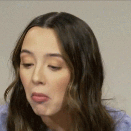 A Close Up Of A Woman Making A Funny Face . GIF