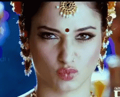 A Close Up Of A Woman Making A Funny Face GIF