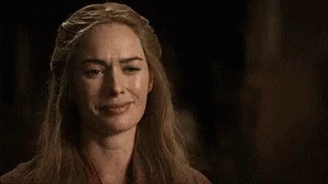 A Close Up Of A Woman Making A Funny Face In The Dark . GIF