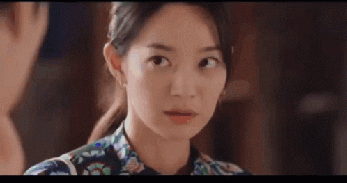 A Close Up Of A Woman Making A Funny Face While Looking At The Camera . GIF