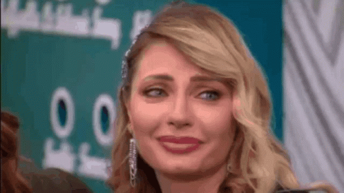 a close up of a woman making a funny face with her eyes closed .