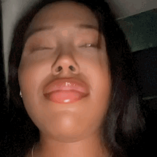 A Close Up Of A Woman Making A Funny Face With Her Eyes Closed . GIF