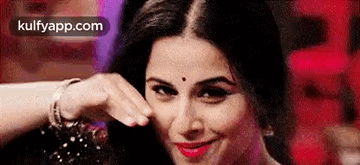 A Close Up Of A Woman Making A Funny Face With Her Hand On Her Face . GIF