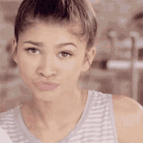 A Close Up Of A Woman Making A Funny Face With Her Mouth Open . GIF