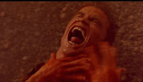 A Close Up Of A Woman Making A Funny Face With Her Mouth Open And Big Red Eyes . GIF