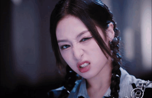 A Close Up Of A Woman Making A Funny Face With Her Mouth Open GIF