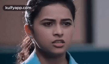 A Close Up Of A Woman Making A Funny Face With Her Mouth Open . GIF