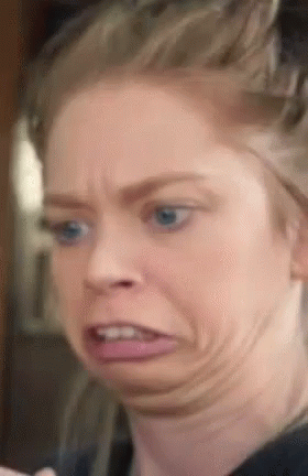 A Close Up Of A Woman Making A Funny Face With Her Mouth Open GIF