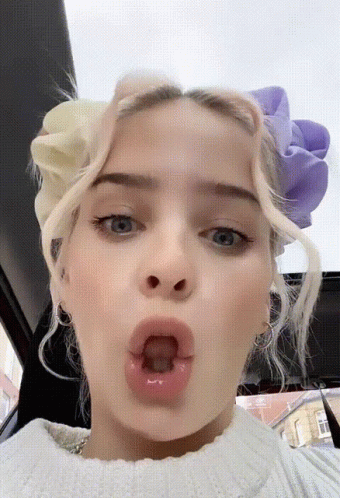 A Close Up Of A Woman Making A Funny Face GIF