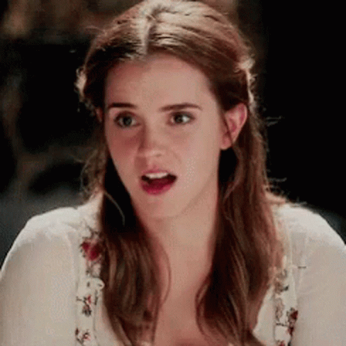 A Close Up Of A Woman Making A Surprised Face While Wearing A White Shirt . GIF