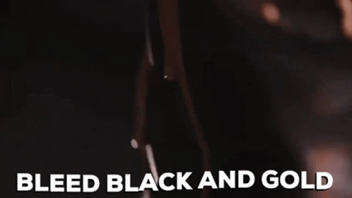 A Close Up Of A Woman 'S Breast With The Words Bleed Black And Gold Written On It . GIF