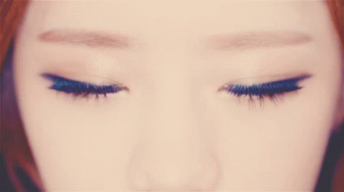 A Close Up Of A Woman 'S Brown Eyes With A Circle In The Middle GIF