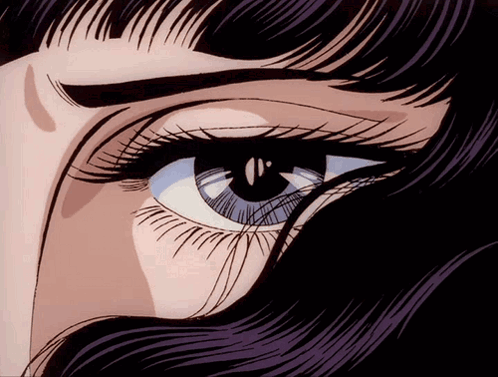 A Close Up Of A Woman 'S Eye With A Purple Fringe GIF