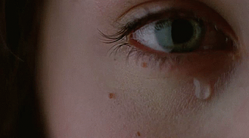 A Close Up Of A Woman 'S Eye With A Tear On It GIF