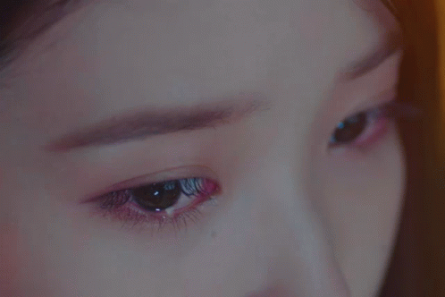 A Close Up Of A Woman 'S Eyes With A Purple Eyeshadow GIF