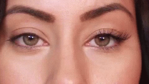 A Close Up Of A Woman 'S Eyes With False Eyelashes And Makeup . GIF