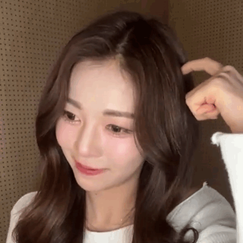 A Close Up Of A Woman 'S Face And Hair With A Person 'S Hand On It . GIF