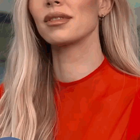A Close Up Of A Woman 'S Face And Neck In A Red Shirt . GIF