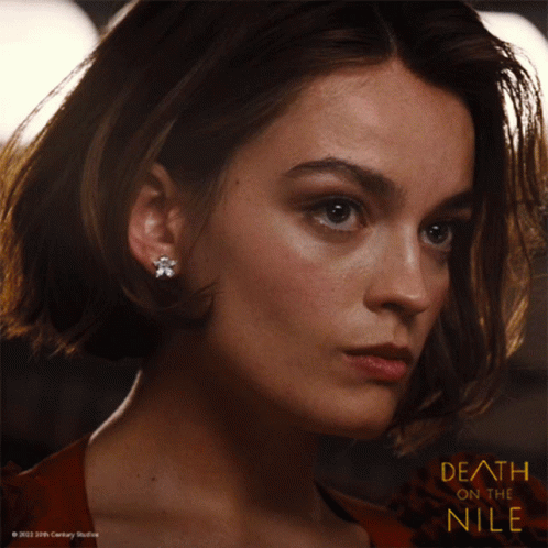 A Close Up Of A Woman 'S Face And The Words Death On The Nile GIF