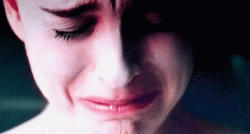 A Close Up Of A Woman 'S Face Crying With Tears Running Down Her Face . GIF