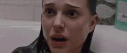 A Close Up Of A Woman 'S Face In A Bathtub With Her Eyes Closed And Tears Running Down Her Face . GIF