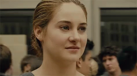 A Close Up Of A Woman 'S Face In A Crowded Room . GIF