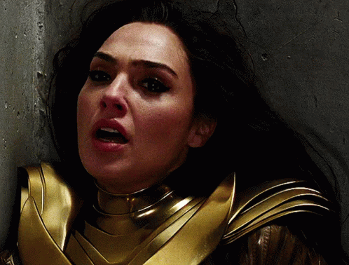 A Close Up Of A Woman 'S Face In A Gold Armor GIF