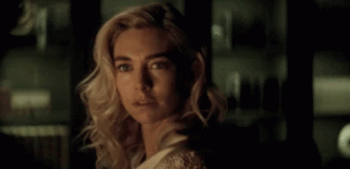 A Close Up Of A Woman 'S Face In The Dark . GIF