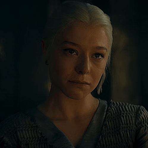 A Close Up Of A Woman 'S Face In The Dark GIF