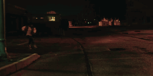 A Close Up Of A Woman 'S Face In The Dark GIF