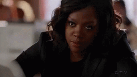 A Close Up Of A Woman 'S Face Looking At The Camera . GIF