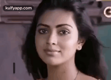 A Close Up Of A Woman 'S Face Looking At The Camera With A Serious Look On Her Face . GIF