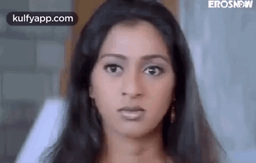A Close Up Of A Woman 'S Face Making A Funny Face . GIF