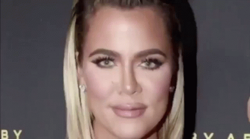 A Close Up Of A Woman 'S Face On A Red Carpet With A Black Background . GIF