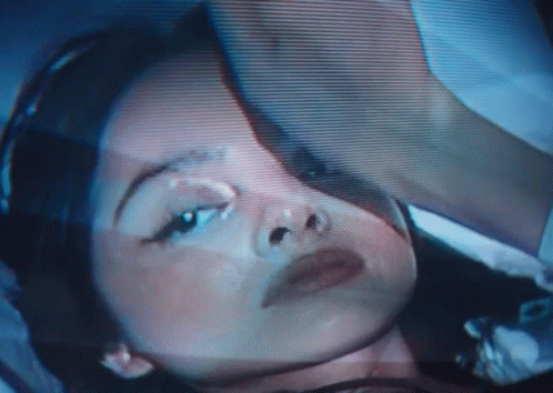 A Close Up Of A Woman 'S Face On A Screen GIF
