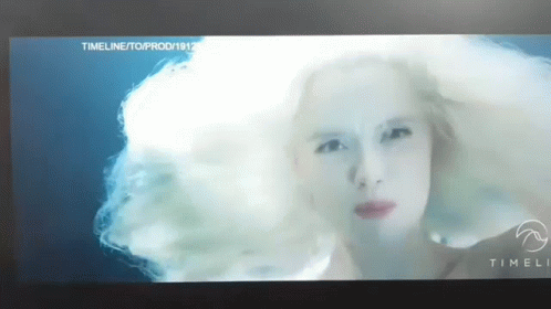 A Close Up Of A Woman 'S Face On A Screen With The Words Timeli On The Bottom GIF