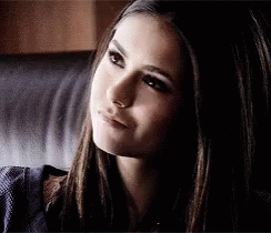 A Close Up Of A Woman 'S Face Sitting On A Couch . GIF