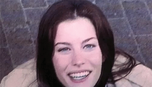A Close Up Of A Woman 'S Face Smiling With Braces On Her Teeth . GIF