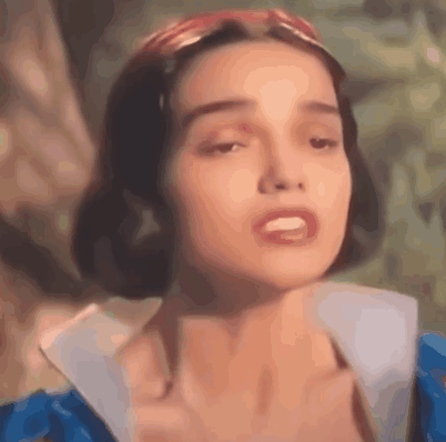 A Close Up Of A Woman 'S Face Wearing A Blue Dress And A Red Headband . GIF