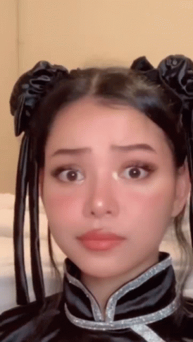 A Close Up Of A Woman 'S Face Wearing A Costume GIF